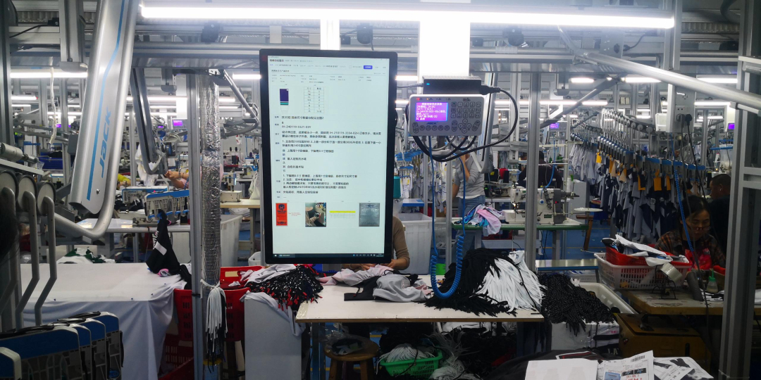 Factory production floor with JACK sewing lines and an in-house QC inspection station
